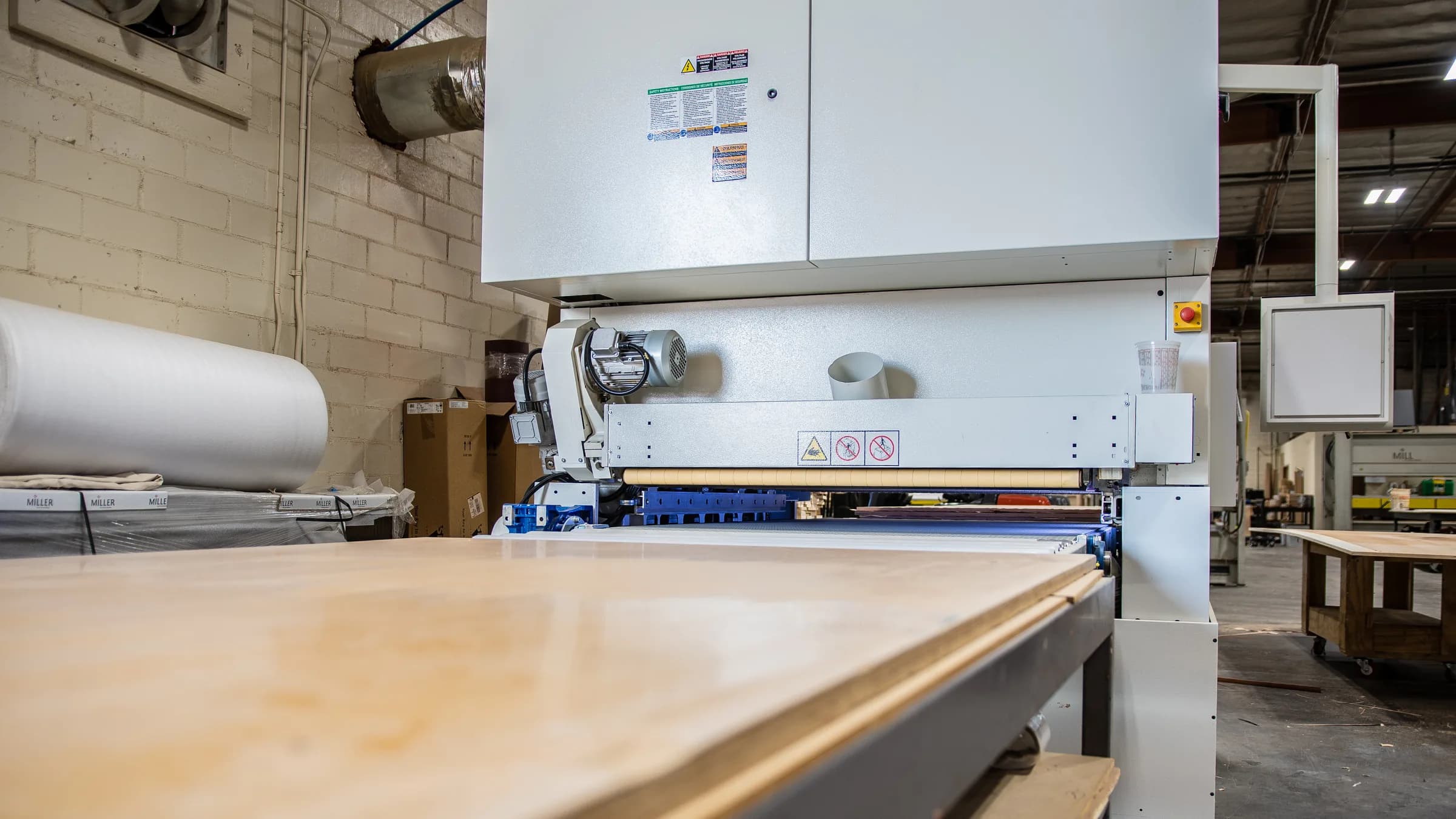 A panel going through the wide-belt sander.